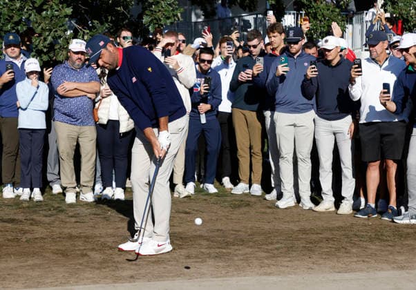 Scottie Scheffler of the United States chips to the fairway on the fourth hole in a four-ball match during the third round of the 2026 President s Cup golf tournament at Medinah Country Club in Chicago, Illinois, on Saturday, September 26, 2026.  CHI20260926723 TANNENxMAURY