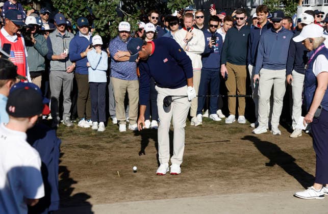 Scottie Scheffler of the United States takes a drop ball on the fourth hole in a four-ball match during the third round of the 2026 President s Cup golf tournament at Medinah Country Club in Chicago, Illinois, on Saturday, September 26, 2026.  CHI20260926724 TANNENxMAURY