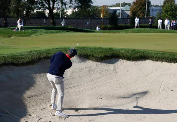 Scottie Scheffler of the United States hits out of a bunker on the fifth hole in a four-ball match during the third round of the 2026 President s Cup golf tournament at Medinah Country Club in Chicago, Illinois, on Saturday, September 26, 2026.  CHI20260926729 TANNENxMAURY