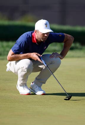 Sam Burns of the United States lines up a putt on the fifth hole in a four-ball match during the third round of the 2026 President s Cup golf tournament at Medinah Country Club in Chicago, Illinois, on Saturday, September 26, 2026.  CHI20260926735 TANNENxMAURY