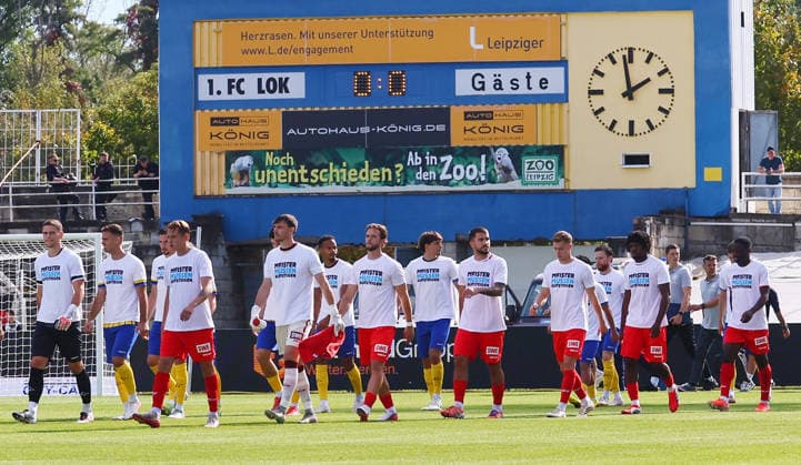 Leipzig, September 26, 2026, Bruno Plache Stadium, Regionalliga Northeast, Soccer, Matchday 11, 1 FC LOK LEIPZIG vs. FC ROT WEISS ERFURT. Pictured: The teams taking the field, protesting the current Regionalliga regulations and calling for reform, Picture Point