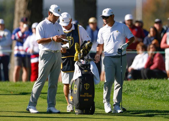 International team player Hideki Matsuyama and teammate Ryo Hisatsune of Japan talk on the sixth fairway in a four-ball match during the third round of the 2026 President s Cup golf tournament at Medinah Country Club in Chicago, Illinois, on Saturday, September 26, 2026.  CHI20260926740 TANNENxMAURY