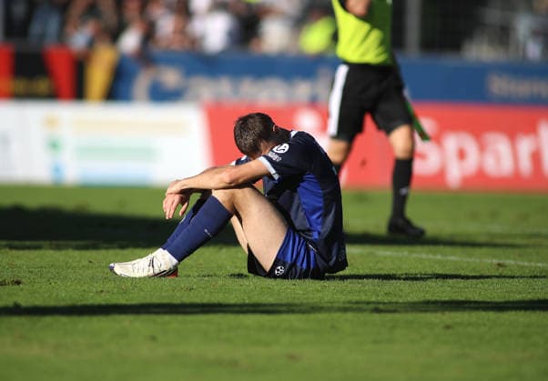 Soccer, Men s, Bavarian Regional League, 2026–2027 Season, SV Wacker Burghausen vs. TSV 1860 Munich, flatbuy Stadium on Liebigstraße; Emre Erdogan of TSV 1860 Munich, looking disappointed and dejected as he sits on the field after the final whistle
