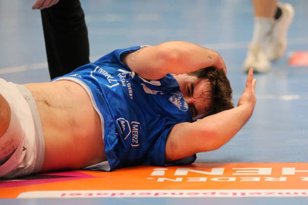 September 26, 2026 Men s Handball 2026–2027, 2nd Handball Bundesliga, Matchday 5: Dessau Roßlauer HV 06 1 VfL Potsdam, Anhalt Arena, Dessau, Marcel Nowak, Dessau, 15, in blue, lies on the floor after being hit in the head Dessau-Roßlau Saxony-Anhalt Germany