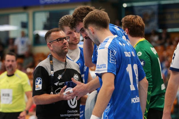 September 26, 2026 Men s Handball 2026–2027, 2nd Division, Matchday 5: Dessau Roßlauer HV 06 1 VfL Potsdam, Anhalt Arena, Dessau; Marcel Nowak, Dessau, 15, blue, talking to physio Ive Lassanske after being hit in the head by David Misovych; Dessau, 18, blue, asking about his teammate; Dessau-Roßlau, Saxony-Anhalt, Germany
