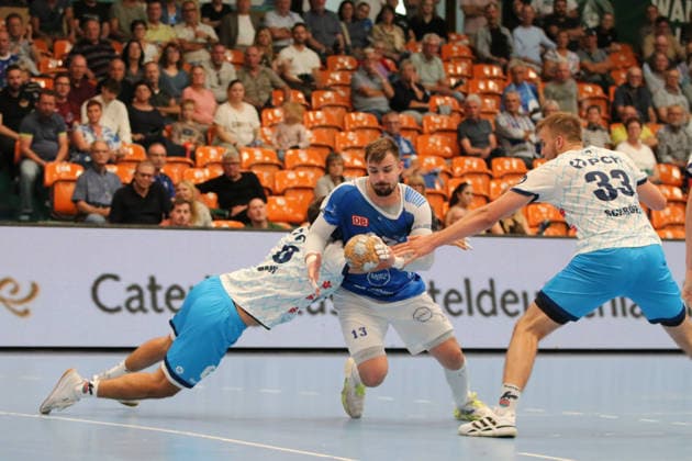 September 26, 2026 Men s Handball 2026–2027, 2nd Handball Bundesliga, Matchday 5: Dessau Roßlauer HV 06 1, VfL Potsdam, Anhalt Arena, Dessau. Valentin Neagu (Dessau, 13, in blue) goes head-to-head with Markus Mahr (Potsdam, 6, in white, and Tim Schröder (Potsdam, 33, in white) Dessau-Roßlau, Saxony-Anhalt, Germany
