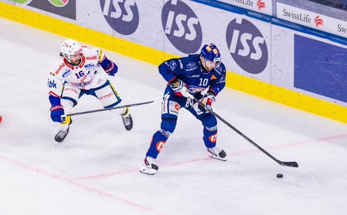 Ice Hockey National League Regular Season: ZSC Lions vs. EHC Kloten, Zurich, Switzerland, September 26, 2026. No. 10 Sven Andrighetto of the ZSC Lions defends the puck in a duel against No. 16 Bernd Wolf of Kloten. Copyright: xAndreasxHaasx