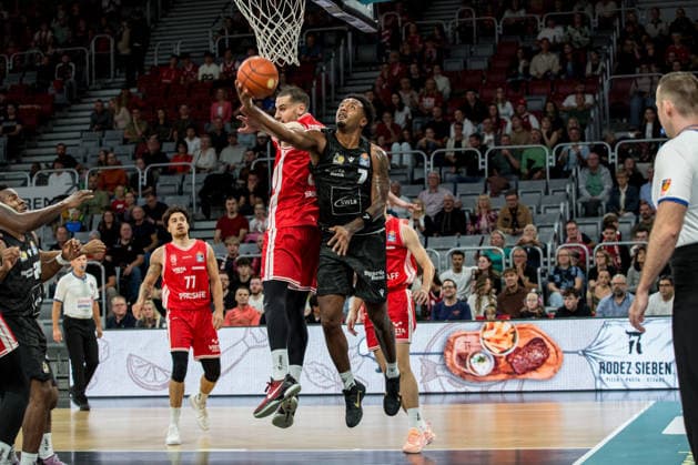 Bamberg, Germany, September 26, 2026, 1 BBL 2026–2027, Game 3: BMA365 Bamberg Baskets vs. MHP Riesen Ludwigsburg. Pictured: Elijah Hughes. Ludwigsburg drives through the Bamberg zone and past Daniel Keppeler. Bamberg Brose Arena, Bavaria Copyright: xFotostandx xSchmittx