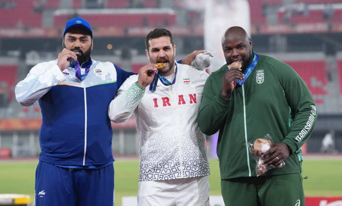 (260926) -- NAGOYA, Sept. 26, 2026 -- Gold medalist Mohammadreza Tayebise (C) of Iran, silver medalist Tajinderpal Singh Toor (L) of India and bronze medalist Mohammed Tolu of Saudi Arabia pose during the awarding ceremony for the men s shot put of Athletics at the 20th Asian Games Aichi-Nagoya 2026 in Nagoya, Japan, Sept. 26, 2026. ) (SP)JAPAN-NAGOYA-ASIAN GAMES-ATHLETICS-SHOT PUT-MEN S FINAL LuoxYuan 