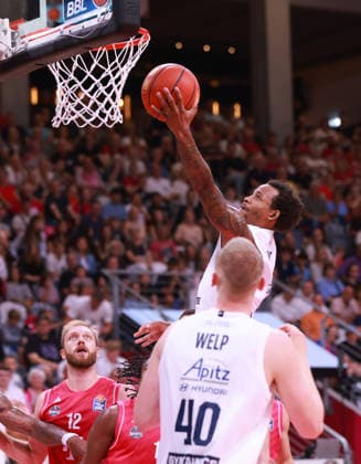 DeLonnie Hunt of MBC shoots the ball as Melvin Jostmann of Bonn and Collin Welp of MBC look on, Bonn, Germany, September 27, 2026, Basketball Bundesliga, Matchday 3, Telekom Baskets Bonn vs. Syntainics MBC