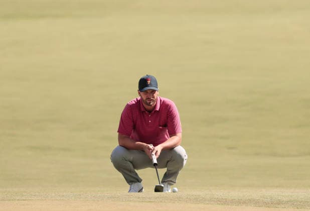 Wyndham Clark of the United States lines up a putt on the third hole during a singles match on the final day of the 2026 President s Cup golf tournament at Medinah Country Club in Chicago, Illinois, on Sunday, September 27, 2026.  CHI20260927720 TANNENxMAURY