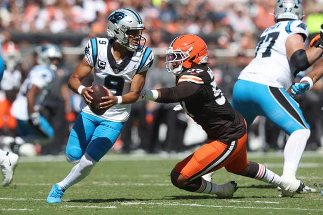 Carolina Panthers quarterback Bryce Young (9) evades Cleveland Browns Isaiah McGuire (57) during the second quarter at Huntington Bank Field in Cleveland, Ohio on Sunday September 27, 2026.  CLE20260927111 AARONxJOSEFCZYK