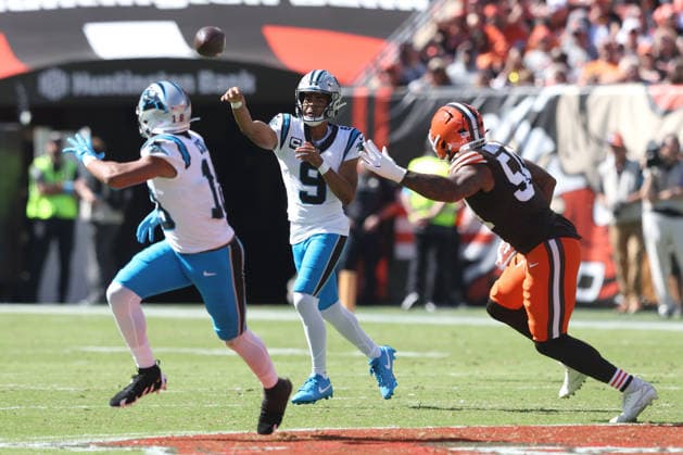 Carolina Panthers quarterback Bryce Young (9) throws a pass to Jalen Coker (18) while pursued by Cleveland Browns Sam Williams (54) in the second quarter at Huntington Bank Field in Cleveland, Ohio on Sunday September 27, 2026.  CLE20260927112 AARONxJOSEFCZYK