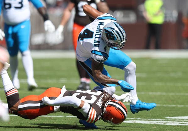 Carolina Panthers Teteriroa McMillan (4) is taken down by Cleveland Browns Ronnie Hickman (33) after making a catch in the first quarter at Huntington Bank Field in Cleveland, Ohio on Sunday September 27, 2026.  CLE20260927113 AARONxJOSEFCZYK