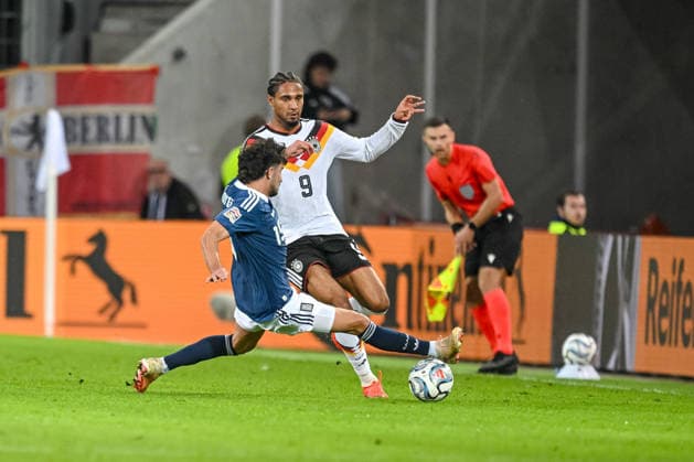 Thanasis Androutsos of Greece and Kevin Schade of Germany battle for the ball during the UEFA Nations League 2026–27 group stage match between Germany and Greece at WWK Arena on September 27, 2026, in Augsburg, Germany. Photo by Harry Langer, DeFodi Images