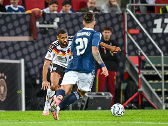 Josha Vagnoman of Germany and Kostas Tsimikas of Greece battle for the ball during the UEFA Nations League 2026–27 group stage match between Germany and Greece at WWK Arena on September 27, 2026, in Augsburg, Germany. Photo by Harry Langer, DeFodi Images