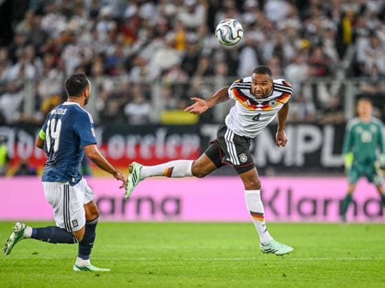 Vangelis Pavlidis of Greece and Jonathan Tah of Germany battle for the ball during the UEFA Nations League 2026–27 group stage match between Germany and Greece at WWK Arena on September 27, 2026, in Augsburg, Germany. Photo by Harry Langer, DeFodi Images