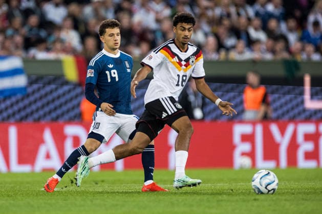 AUGSBURG, GERMANY - SEPTEMBER 27: Nathaniel Brown (Germany, 18) controls the ball against Konstantinos Karetsas (Greece, 19) during the UEFA Nations League match between Germany vs. Greece at WWK Arena on matchday 2 of the UEFA Nations League on September 27, 2026 in Augsburg, Germany. Bavaria Germany Copyright: xSteffiexWunderlx