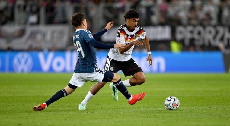 SOCCER UEFA Nations League League A Group 2 2026–2027 in Augsburg, September 27, 2026: Germany vs. Greece—Konstantinos Karetsas (left), Greece, vs. Nathaniel Brown (right), Germany