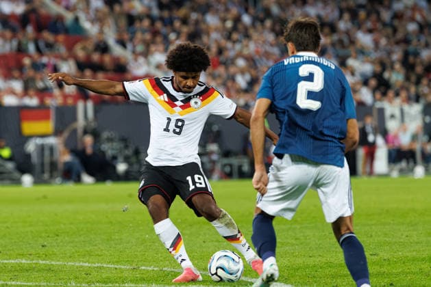 Karim Adeyemi 19, Germany (in the foreground), Giorgos Vaginnidis 2, Greece, during the match between Germany and Greece, soccer, men s, UEFA Nations League, 2026–2027, Matchday 2 on September 27, 2026, in Augsburg, WWK Arena, Bavaria, Germany