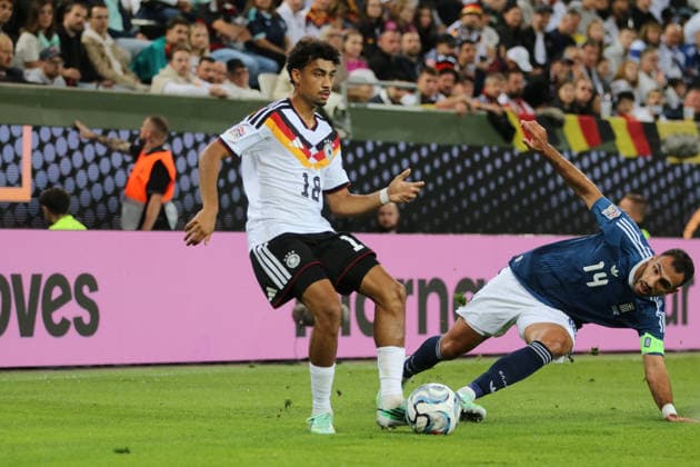 September 27, 2026 Men s Soccer 2026–2027 UEFA Nations League Matchday 2 Germany vs. Greece WWK Arena, Augsburg Nathaniel Brown (Germany, 18, white) plays a pass; Vangelis Pavlidis (Greece, 14, blue) arrives too late Augsburg, Bavaria, Germany