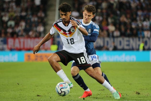 September 27, 2026 Men s Soccer 2026–2027 UEFA Nations League Matchday 2 Germany vs. Greece WWK Arena, Augsburg Nathaniel Brown (Germany, 18, in white) in a tackle with Konstantinos Karetsas (Greece, 19, in blue) Augsburg, Bavaria, Germany
