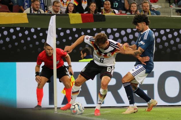 September 27, 2026 Men s Soccer 2026–2027 UEFA Nations League Matchday 2 Germany vs. Greece WWK Arena, Augsburg Joshua Kimmich (Germany), 6, in white, shields the ball from Thanasis Androutsos of Greece, 15, in blue, at the corner flag Augsburg, Bavaria, Germany