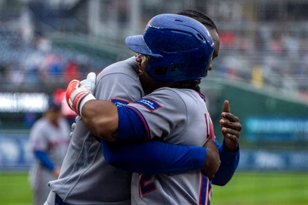 New York Mets short stop Francisco Linder (12) hugs New York Mets designated hitter Ronny Mauricio (0) after hitting his 300th career home run in the top of the second inning during a game against the Washington Nationals at Nationals Park in Washington, DC on Sunday, September 27, 2026.  WAP20260927317 BONNIExCASH