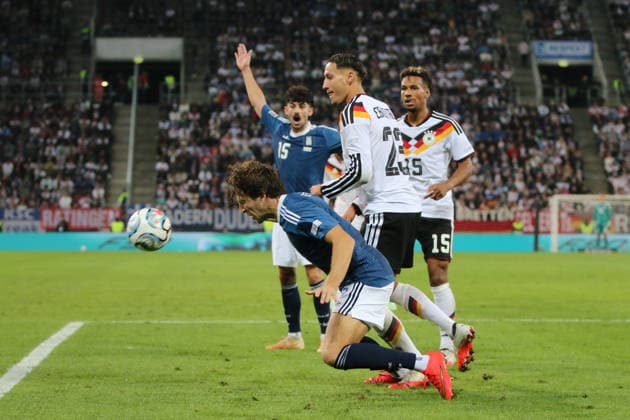 September 27, 2026 Men s Soccer 2026–2027 UEFA Nations League Matchday 2 Germany vs. Greece WWK Arena, Augsburg Younes Ebnoutalib (Germany, 23, white) in a tackle with Panagiotis Retsos (Greece, 5, blue) Augsburg, Bavaria, Germany