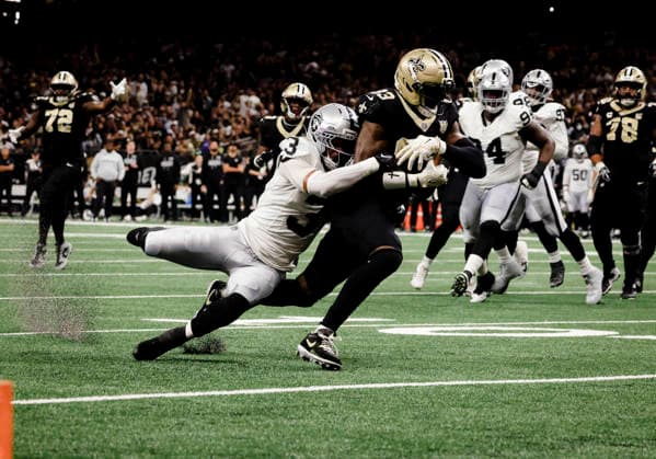 NEW ORLEANS, LA - SEPTEMBER 27: Juwan Johnson 83 of the New Orleans Saints is tackled by Taron Johnson 3 of the Las Vegas Raiders during the first half of an NFL, American Football Herren, USA game on September 27. 2026, at Caesars Superdome in New Orleans, Louisiana. (Photo by Derick Hingle Icon Sportswire) NFL: SEP 27 Raiders at Saints EDITORIAL USE ONLY Icon12626927011