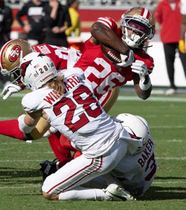 San Francisco 49ers running back Kaelon Black (26) is tackled by Arizona Cardinals safety Andrew Wingard (28) and safety Budda Baker (3) in the second half at Levi s Stadium in Santa Clara, California on Sunday, September 27, 2026. The 49ers defeated the Cardinals 36 to 30.  SXP2026092716 TerryxSchmitt