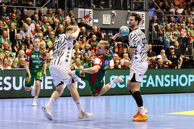 Gisli Kristjansson, SC Magdeburg (10), against Eric Johansson (THW Kiel, 21) and Veron Nacinovic (THW Kiel, 93). Handball Bundesliga Season 2026–2027: SC Magdeburg vs. THW Kiel at the GETEC Arena in Magdeburg. Action, handball,Germany, September 30, 2026