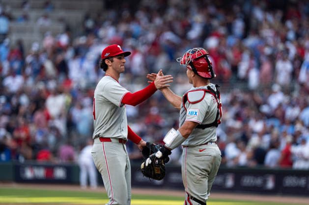 Andrew Painter 24 of the Philadelphia Phillies celebrating with J.T. Realmuto 10 of the Philadelphia Phillies after they won against the Atlanta Braves in game two of the MLB, Baseball Herren, USA National League Wild Card round at Truist Park on Wednesday, September 30, 2026 in Atlanta, Georgia.  ATL20260930143 STEVENxBURROUGHS