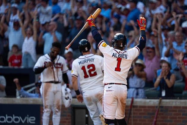Ozzie Albies 1 of the Atlanta Braves celebrating teammates Sean Murphy 12 of the Atlanta Braves running home in the seventh inning against the Philadelphia Phillies in game two of the MLB, Baseball Herren, USA National League Wild Card round at Truist Park on Wednesday, September 30, 2026 in Atlanta, Georgia.  ATL20260930113 STEVENxBURROUGHS