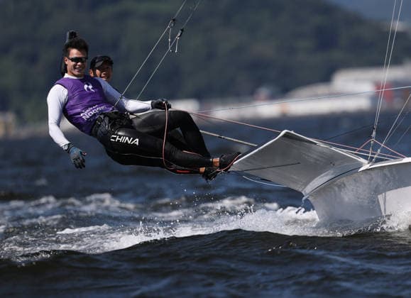 (261001) -- GAMAGORI, Oct. 1, 2026 -- Liu Tian (front) and Wen Zaiding of China celebrate after the Men s Skiff Opening Series Race of Sailing at the 20th Asian Games Aichi-Nagoya 2026 in Gamagori of Aichi Prefecture, Japan, Oct. 1, 2026. ) (SP)JAPAN-GAMARORI-ASIAN GAMES-SAILING-MEN S SKIFF DengxHua 
