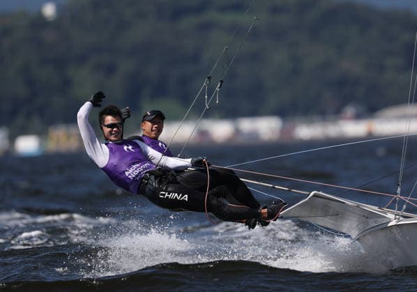 (261001) -- GAMAGORI, Oct. 1, 2026 -- Liu Tian (front) and Wen Zaiding of China celebrate after the Men s Skiff Opening Series Race of Sailing at the 20th Asian Games Aichi-Nagoya 2026 in Gamagori of Aichi Prefecture, Japan, Oct. 1, 2026. ) (SP)JAPAN-GAMAGORI-ASIAN GAMES-SAILING-MEN S SKIFF DengxHua