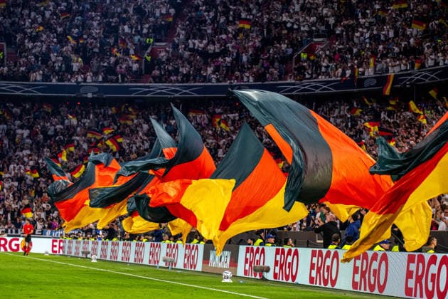German flags waved during goal celebrations at the UEFA Nations League match between Germany and Serbia on October 1, 2026, at the Allianz Arena in Munich, Bavaria, Germany