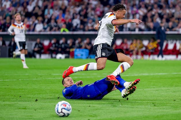 October 1, 2026, Soccer, International Match, Germany vs. Serbia, 2026–2027 UEFA Nations League, Matchday 3, Allianz Arena, Munich, 2026–27 season. Nemanja Maksimovic (SER 5) in a tackle against Derry Scherhant (GER 9). DFB regulations prohibit any use of photographs as image sequences and or quasi-video. Bayern Munich, Germany
