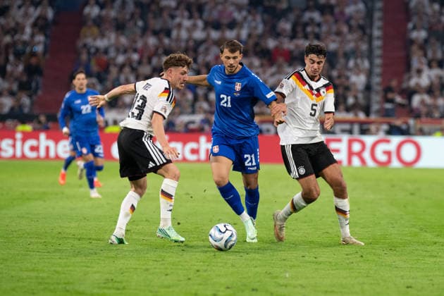 Philipp Treu (13, Germany), Lazar Samardzic (21, Serbia), and Aleksandar Pavlovic (5, Germany) in action during the UEFA Nations League match between Germany and Serbia on October 1, 2026, at the Allianz Arena in Munich, Bavaria, Germany