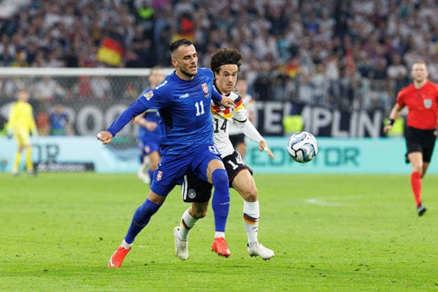 Filip Kostic (11), Serbia, and Mika Baur (14), Germany, during the match between Germany and Serbia, men s soccer, UEFA Nations League, 2026–2027, Matchday 3 on October 1, 2026, in Munich, Allianz Arena, Bavaria, Germany