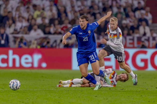 Munich, Germany, October 1, 2026 UEFA Nations League 2026–2027 League Phase Group A2 Match 3 Germany vs. Serbia Pictured from left in a tackle: Lazar Samardzic (SRB), Maximilian Mittelstädt (GER), and Jonathan Burkardt (GER). DFB and DFL regulations prohibit any use of photographs as image sequences and or quasi-video. Allianz Arena, Bayern Copyright: xFotostandx xSchäferx