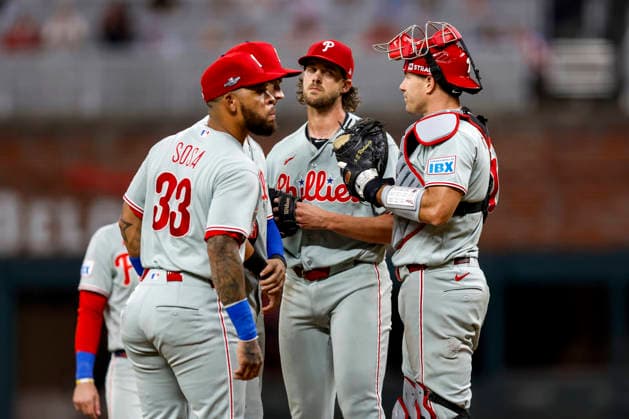 Philadelphia Phillies third baseman Edmundo Sosa (33), Philadelphia Phillies shortstop Trea Turner (7), Philadelphia Phillies pitcher Aaron Nola (27) and Philadelphia Phillies catcher J.T. Realmuto (10) meet on the pitchers mound in the first inning against the Atlanta Braves in Game 3 of the National League Wildcard Series at Truist Park on Thursday, October 1, 2026 in Atlanta, Georgia.  ATL20261001104 MikexZarrilli