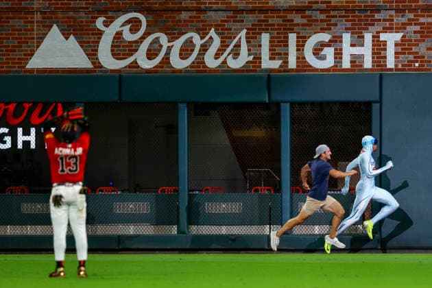 Atlanta Braves right fielder Ronald Acuna Jr. (13) reacts as The Freeze beats a fan the during the Beat the Freeze Race in sixth inning of game three of the MLB, Baseball Herren, USA National League Wild Card round at Truist Park in Atlanta, Georgia on Thursday, October 1, 2026.  ATL20261001320 MIKExZARRILLI