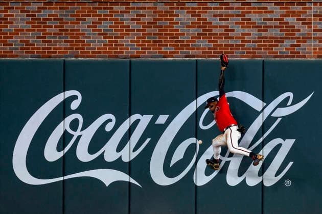 Atlanta Braves right fielder Ronald Acuna Jr. (13) jumps off the wall in an attempt to field a triple from Philadelphia Phillies Derek Hill (49) in the eighth inning in game three of the MLB, Baseball Herren, USA National League Wild Card round at Truist Park in Atlanta, Georgia on Thursday, October 1, 2026.  ATL20261001325a MIKExZARRILLI