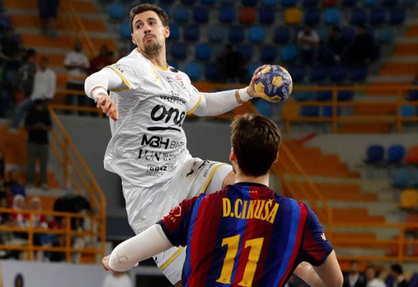 (261002) -- CAIRO, Oct. 2, 2026 -- Ivan Martinovic (top) of Veszprem HC shoots during the gold medal match between Veszprem HC of Hungary and FC Barcelona, Barca of Spain at the 19th IHF Men s Club World Championship, WM, Weltmeisterschaft 2026 in Cairo, Egypt, Oct. 1, 2026. ) (SP)EGYPT-CAIRO-HANDBALL-IHF-MEN S CLUB WORLD CHAMPIONSHIP-GOLD MEDAL MATCH AhmedxGomaa 
