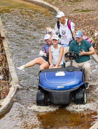 October 1, 2026, Honolulu, Hawaii, USA: HAILEE COOPER (left) and LANEY FRYE (middle) ride a golf cart across a flooded foot bridge next to the 6th tee at the 2026 Lotte Championship at Hoakalei Country Club, Ewa Beach, Hawaii, USA. Even though Hurricane Nolo had already passed Hawaii, its outer bands dropped bouts of heavy rain during Round 1. 2026 Lotte Championship Presented By Hoakalei  - ZUMAm310 20261001_zsp_m310_005 Copyright: xElliotxMilesx