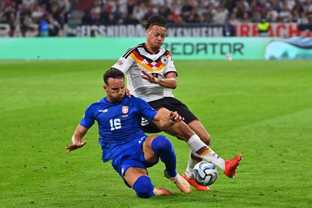 Derry SCHERHANT (GER), Action, One-on-one against Strahinja ERAKOVIC (SRB), UEFA Nations League Group Stage, Group B, Matchday 3: Germany (GER) vs. Serbia (SRB) 2–0 on October 1, 2026, ALLIANZ ARENA