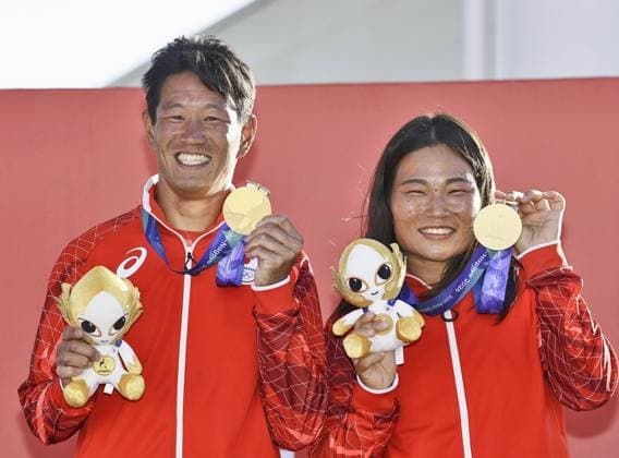 Aichi-Nagoya Asian Games: Sailing Japanese sailors Yurie Seki (R) and Tetsuya Isozaki pose after winning the Aichi-Nagoya Asian Games mixed dinghy gold at Kaiyoh Yacht Harbor in Gamagori in Aichi Prefecture, central Japan, on Oct. 2, 2026.  A14AA0005629736P