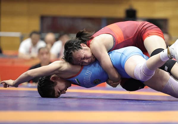 (261002) -- NAGOYA, Oct. 2, 2026 -- Feng Ziqi (top) of China competes with Aktenge Keunimjaeva of Uzbekistan during the women s 50kg bronze medals match of Wrestling at the 20th Asian Games Aichi-Nagoya 2026 in Nagoya, Japan, Oct. 2, 2026. ) (SP)JAPAN-NAGOYA-ASIAN GAMES-WRESTLING-WOMEN S 50KG LongxLei