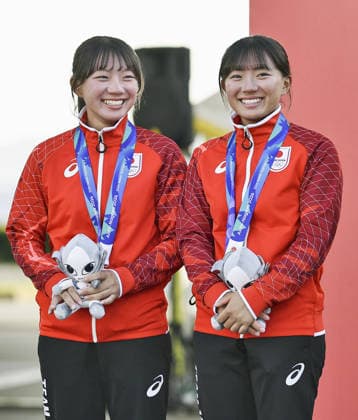 Aichi-Nagoya Asian Games: Sailing Japanese sailors Natsumi Funazawa (R) and Natsuko Funazawa pose after winning the Aichi-Nagoya Asian Games girls skiff silver at Kaiyoh Yacht Harbor in Gamagori in Aichi Prefecture, central Japan, on Oct. 2, 2026. A14AA0005629827P